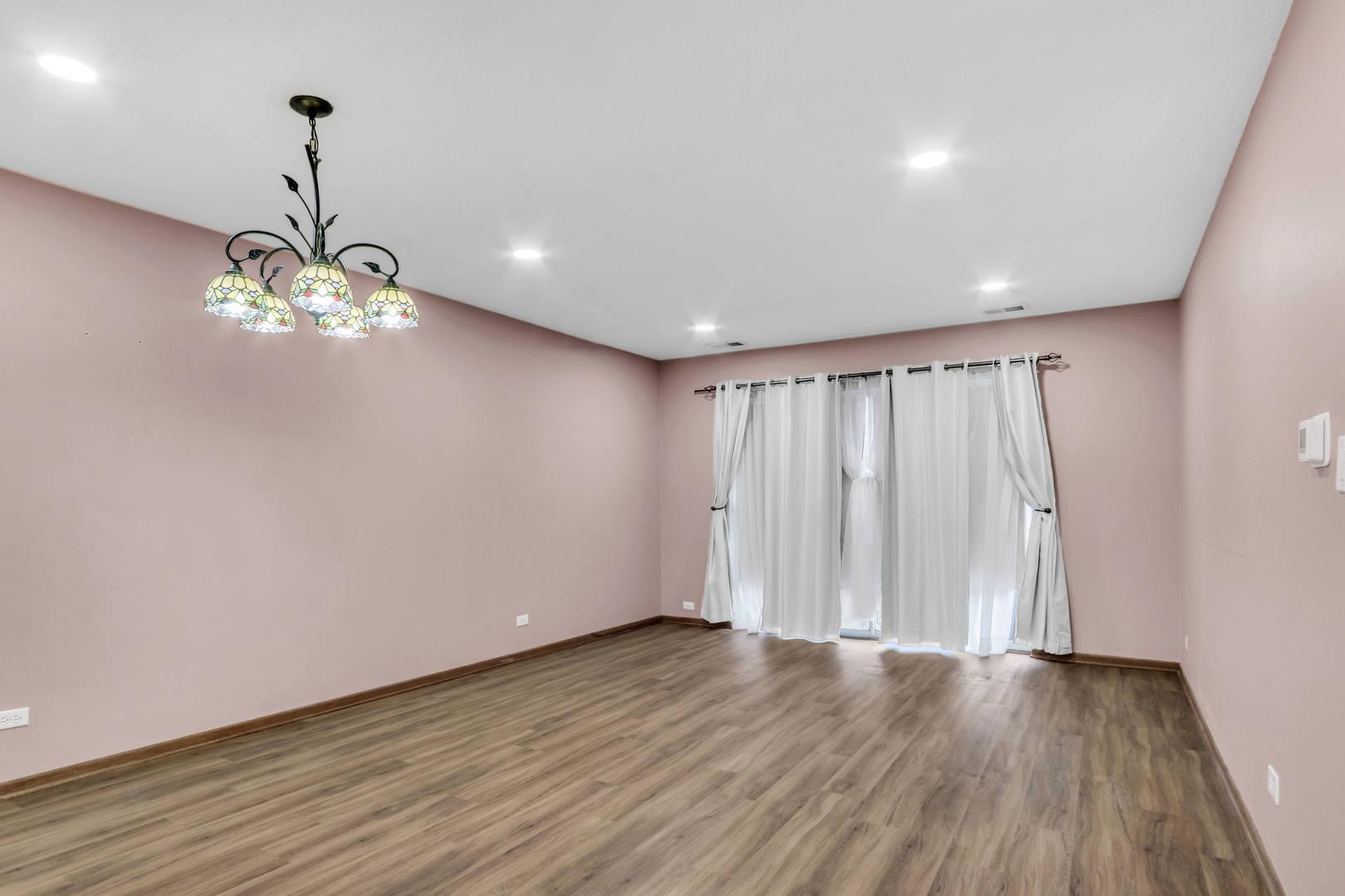 8620 Waukegan Road, Unit 107 Morton Grove, IL 60053 - Photo 5 of 18 a view of a livingroom with a chandelier