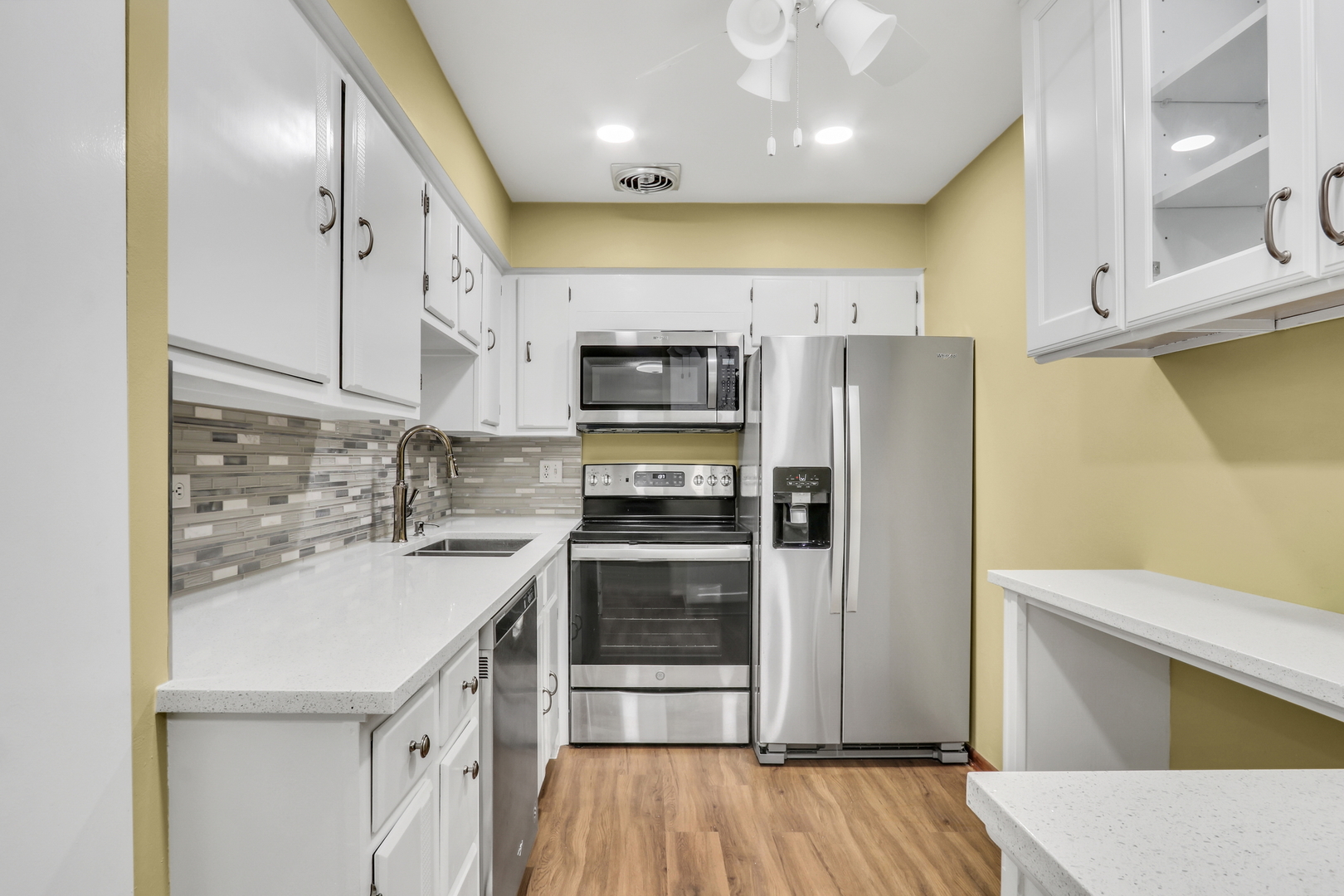 8620 Waukegan Road, Unit 107 Morton Grove, IL 60053 - Photo 7 of 18 a kitchen with a sink stainless steel appliances and cabinets