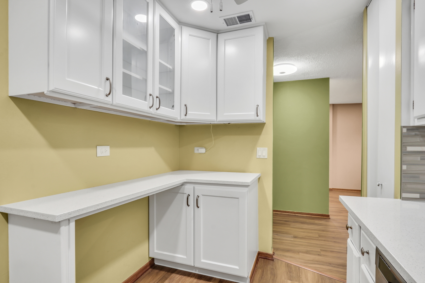8620 Waukegan Road, Unit 107 Morton Grove, IL 60053 - Photo 9 of 18 a view of cabinets with wooden floor