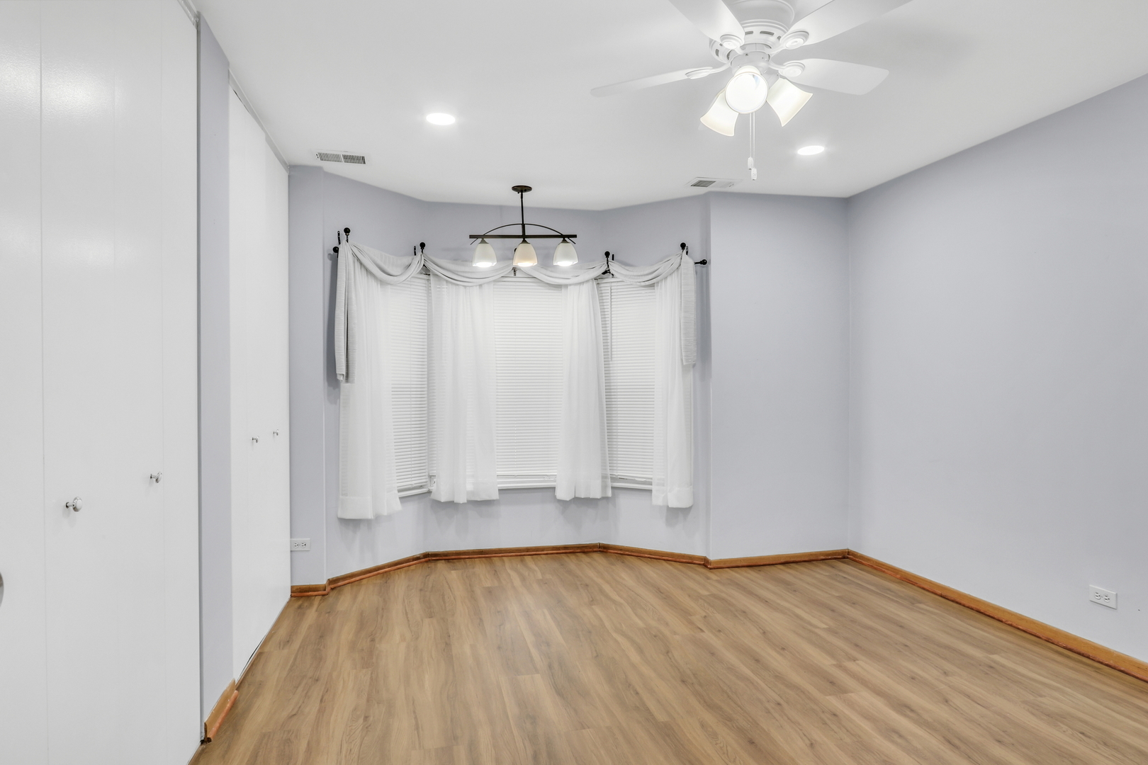 8620 Waukegan Road, Unit 107 Morton Grove, IL 60053 - Photo 10 of 18 wooden floor in an empty room