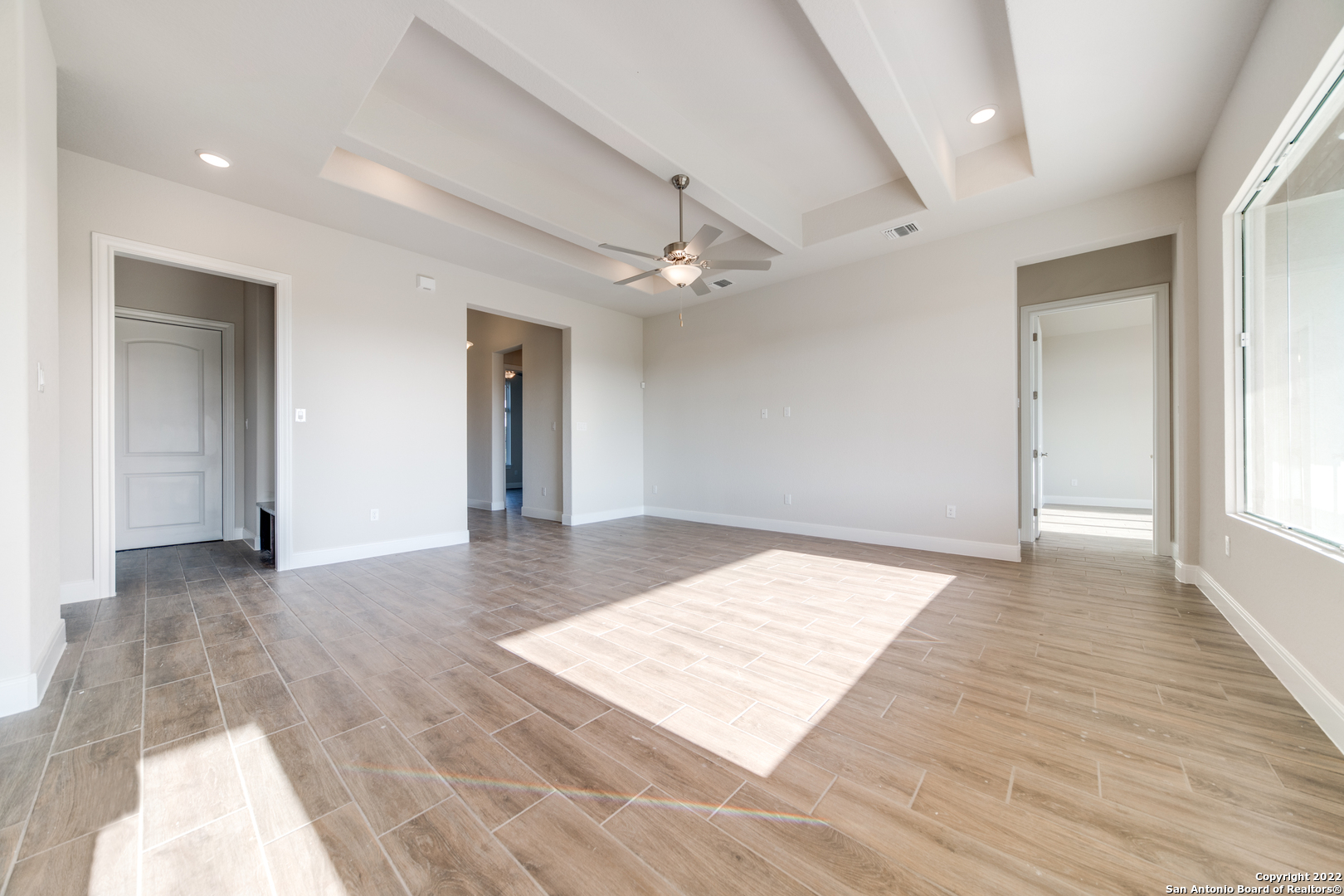 238 Peter Kleid Loop Blanco, TX 78606 - Photo 12 of 25 wooden floor in an empty room with a window