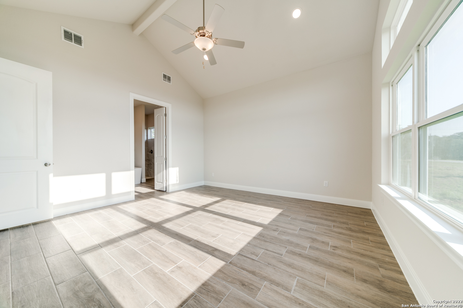 238 Peter Kleid Loop Blanco, TX 78606 - Photo 14 of 25 wooden floor in an empty room with a window