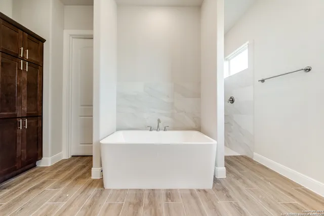 a bathroom with a bathtub and shower