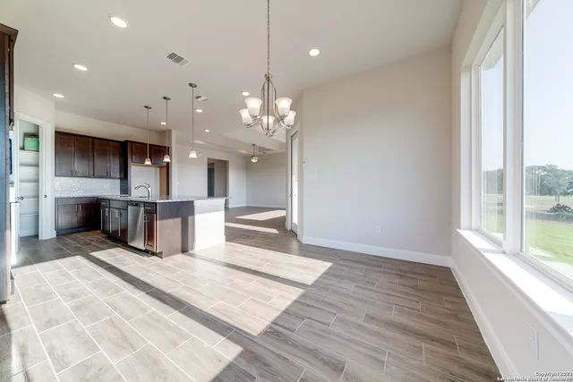 a large kitchen with stainless steel appliances kitchen island granite countertop a sink and cabinets