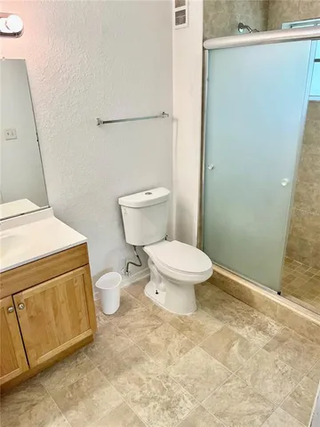 a white toilet sitting next to a sink
