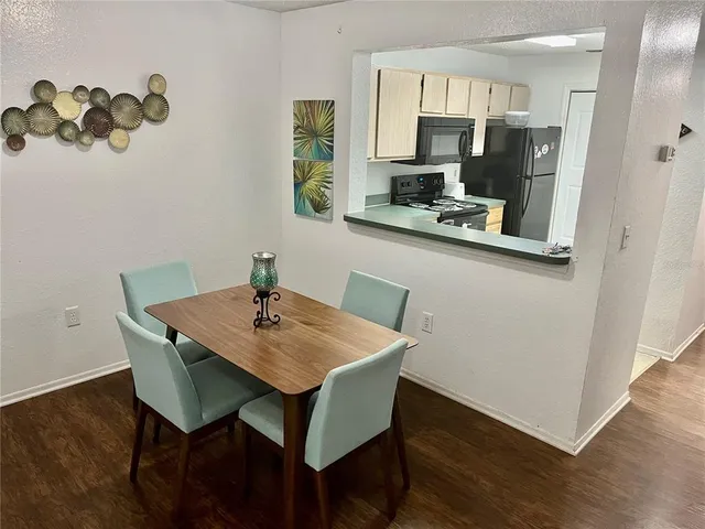 a view of kitchen with sink and wooden floor