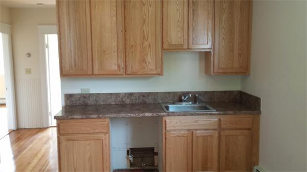 81 Winter Street Bellingham, MA 02019 - Photo 7 of 20 a kitchen with a sink and cabinets