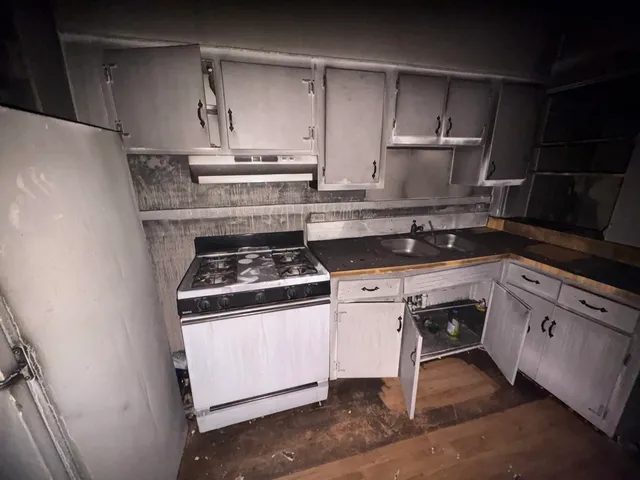 a white stove top oven sitting inside of a kitchen