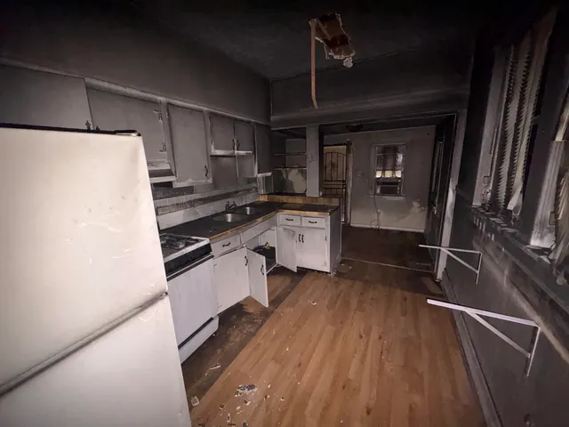 a kitchen with stainless steel appliances a stove a sink and a refrigerator