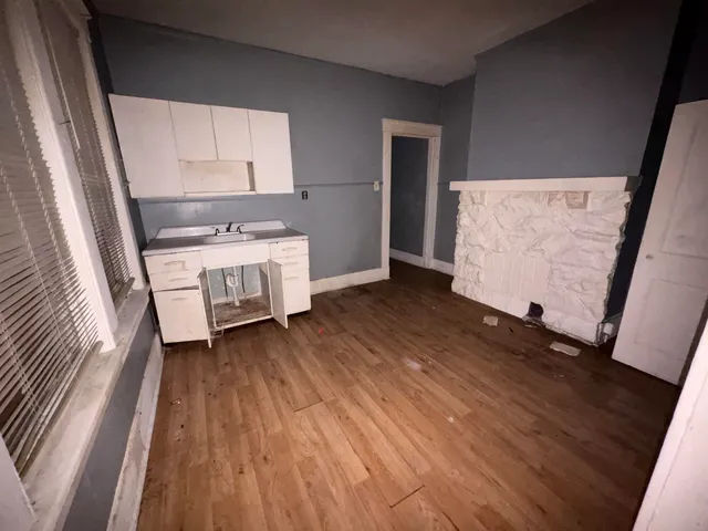 a kitchen with a wooden floor and a stove