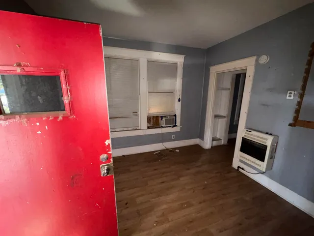 a view of a livingroom with wooden floor and a flat screen tv