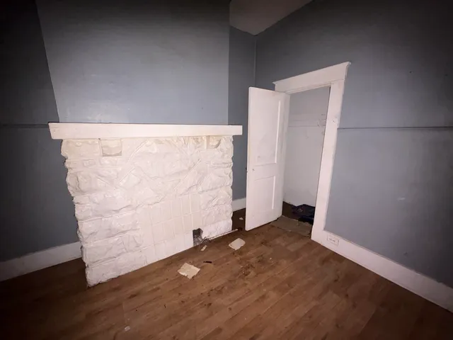 an empty room with wooden floor