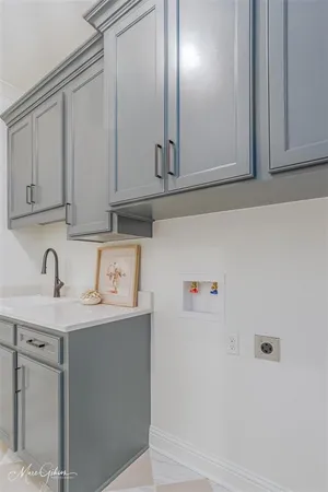 a view of a sink with cabinets