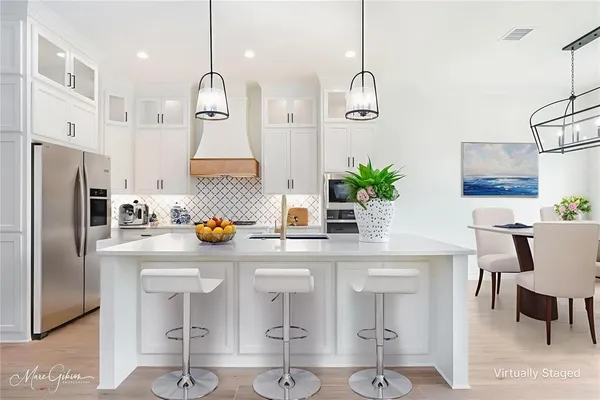 a kitchen with stainless steel appliances a sink and a refrigerator