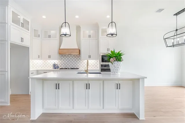 a kitchen with kitchen island granite countertop counter top space cabinets and stainless steel appliances
