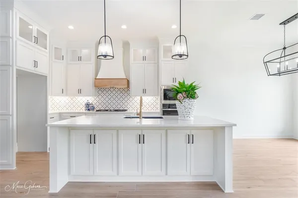 a kitchen with kitchen island granite countertop counter top space cabinets and stainless steel appliances