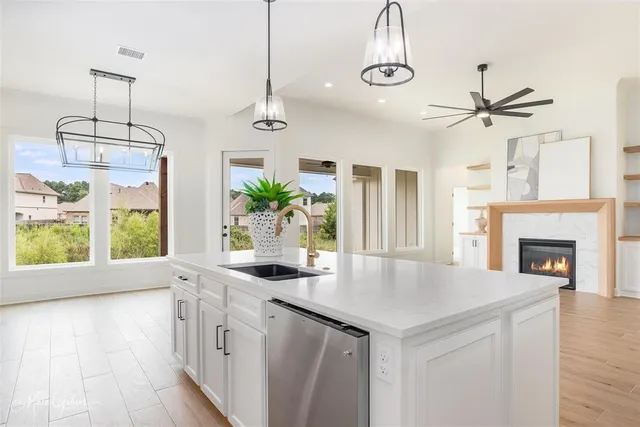 a kitchen with a center island wooden floor and a chandelier