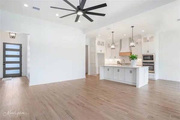a view of kitchen with stainless steel appliances kitchen island