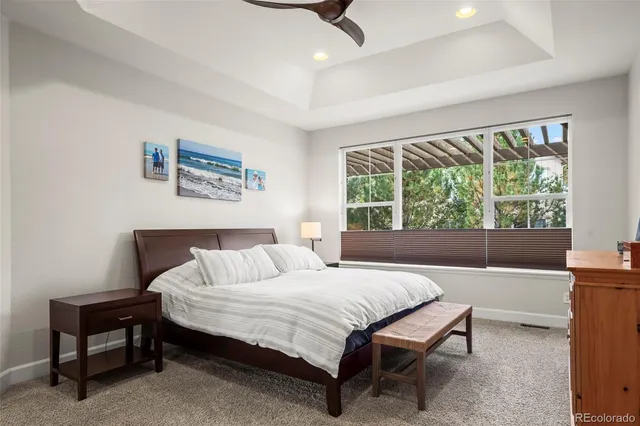 a bedroom with a bed a table and a window