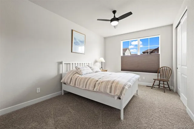a spacious bedroom with a bed and a chandelier