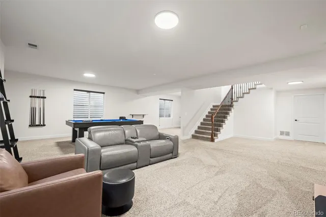 a living room with furniture and a ceiling fan