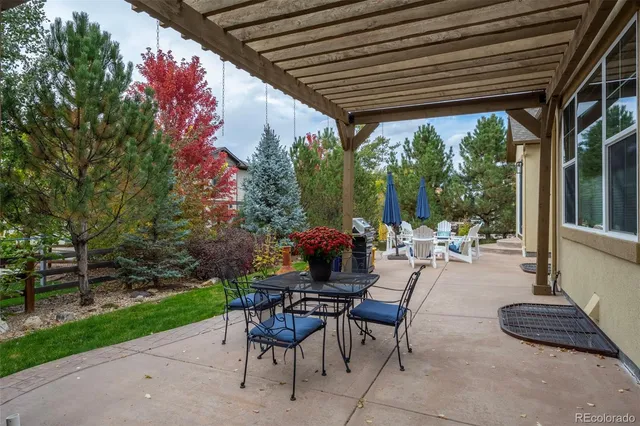 a view of a patio with table and chairs and potted plants