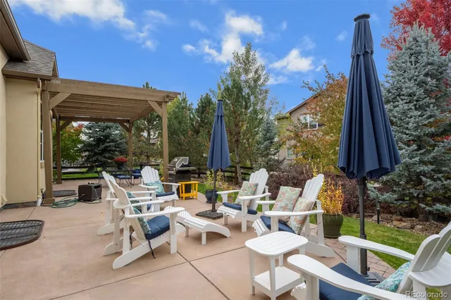 a view of a backyard with sitting area