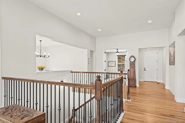 a view of a hallway with wooden floor and windows