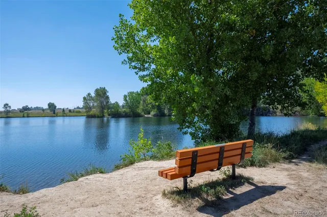 a view of a patio with a table and chairs and potted plants