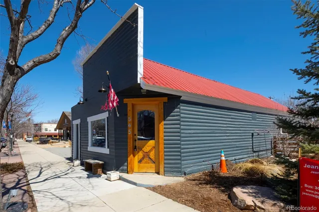 an outdoor sitting area with an umbrella and sitting area