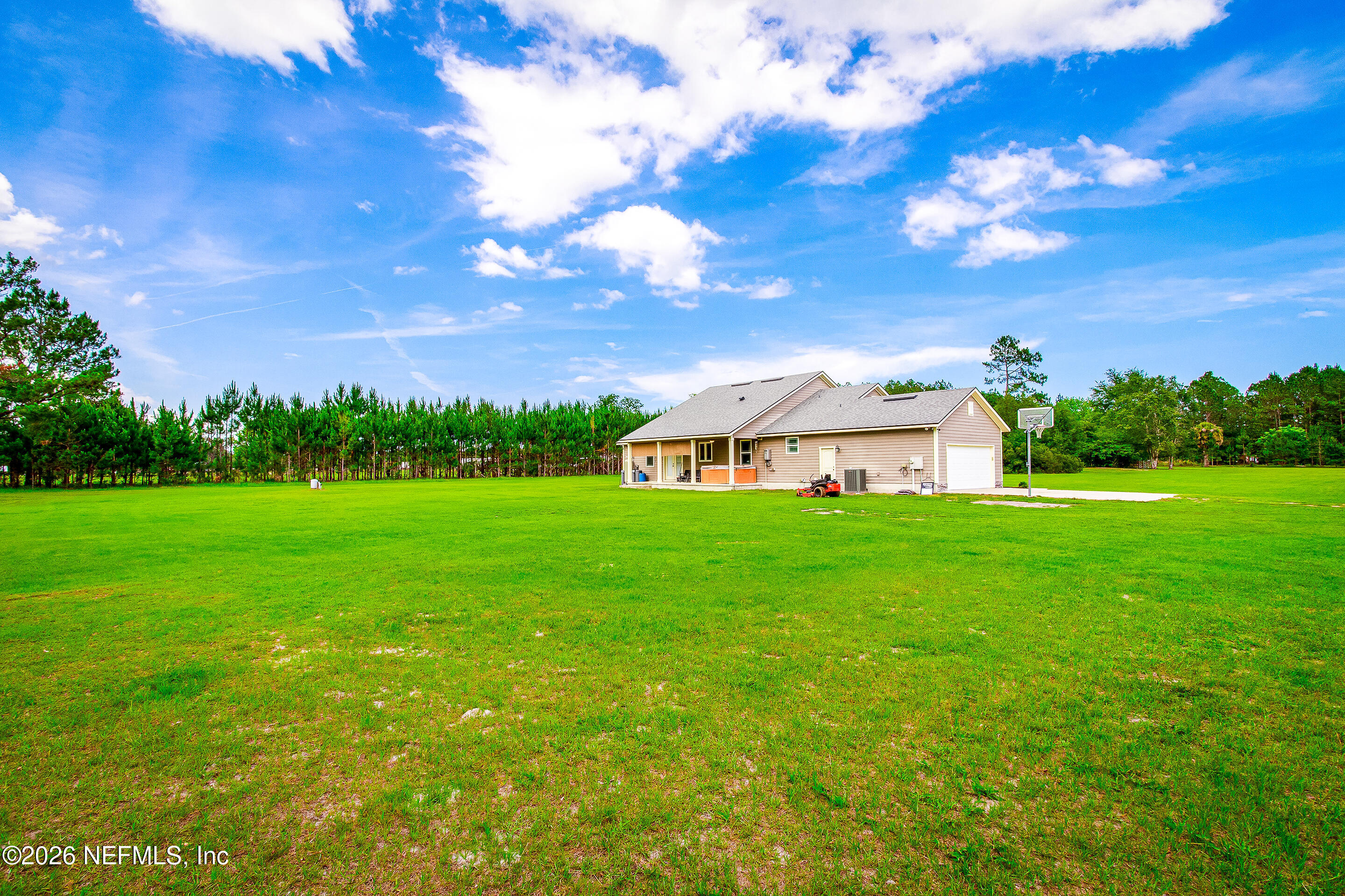 26575 Sheared Stokes Road Hilliard, FL 32046 - Photo 22 of 39 a view of a garden with plants and large trees