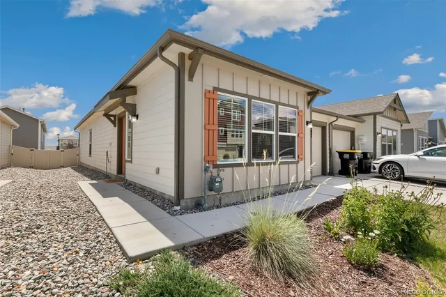 a view of a house with a large window and a yard
