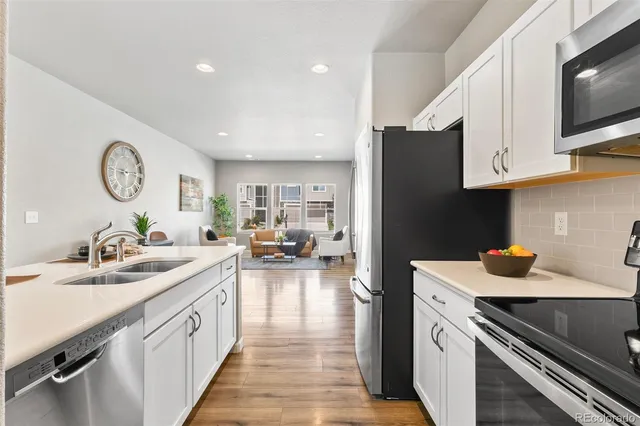 a kitchen with a sink stove and cabinets