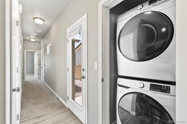 a view of a hallway with washer and dryer