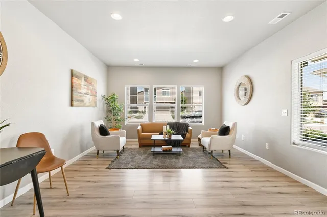 a living room with furniture window and wooden floor