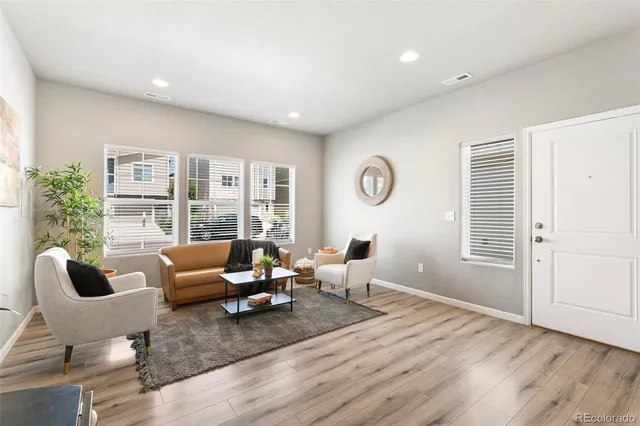 a living room with furniture window and wooden floor