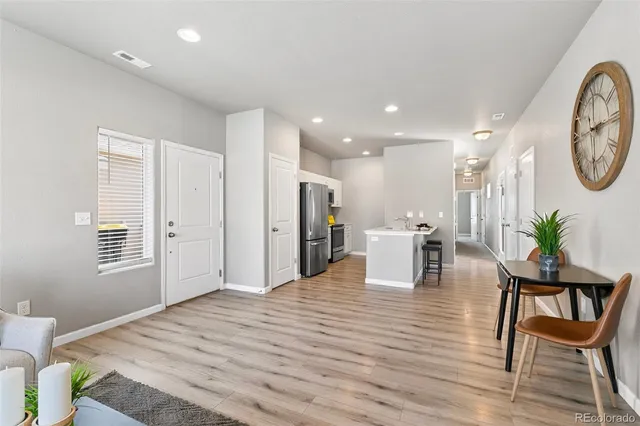 a living room with furniture a window and a dining table