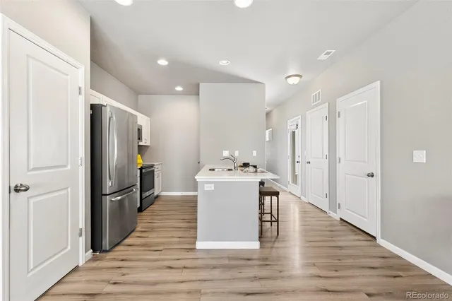 a kitchen with stainless steel appliances a refrigerator and a stove