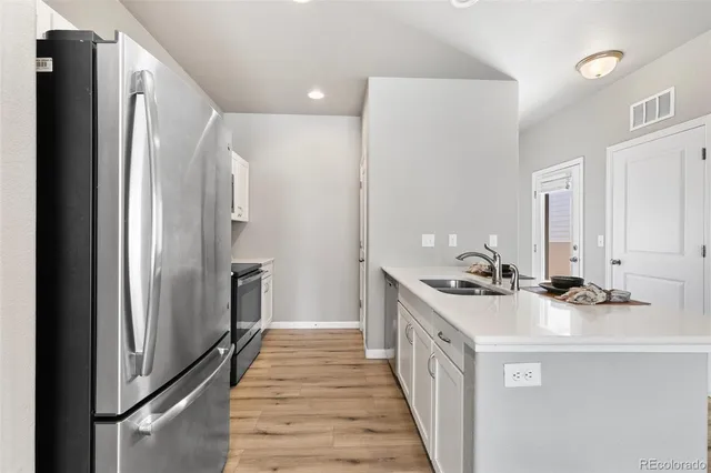 a kitchen with stainless steel appliances a stove and a refrigerator