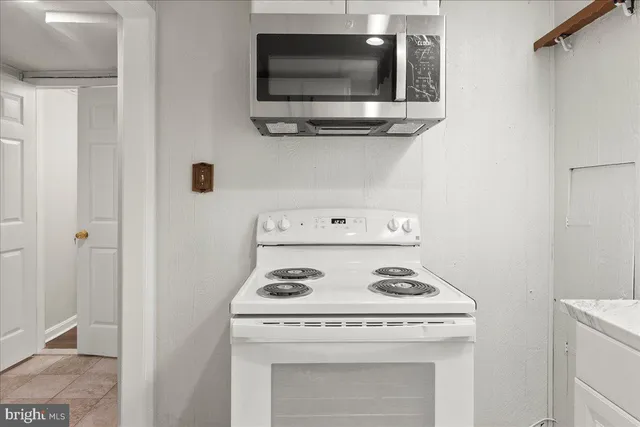 an empty room with a fireplace and a window