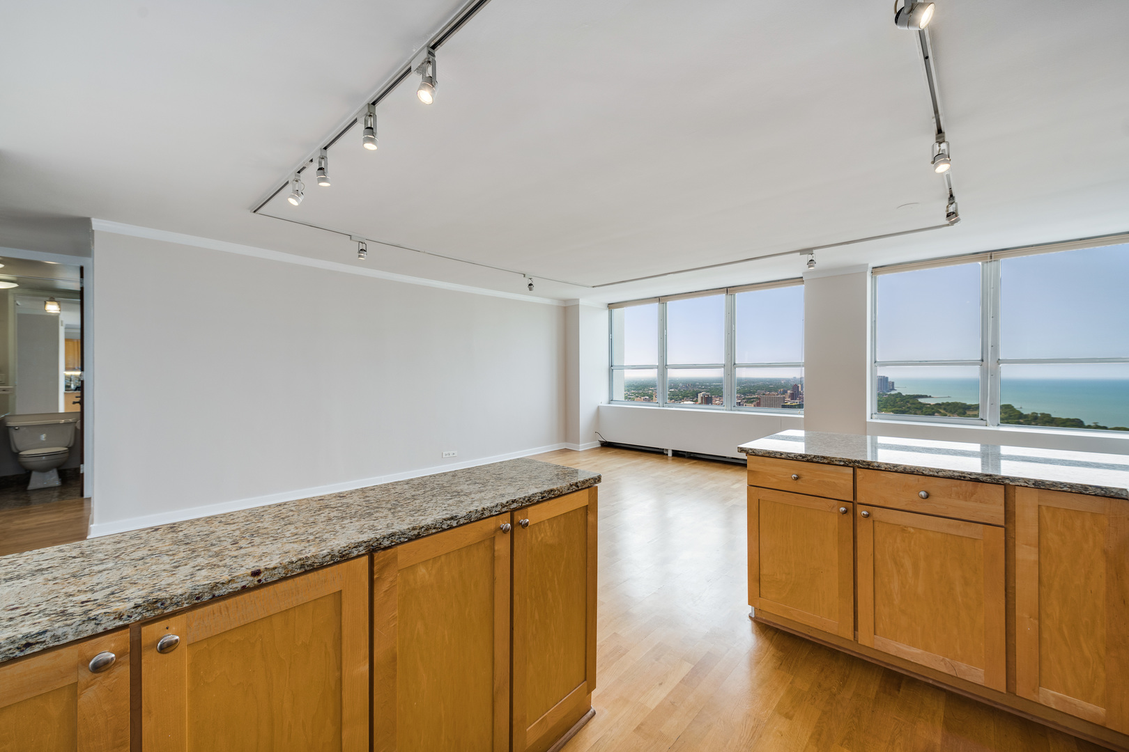 655 West Irving Park Road, Unit 5106 Chicago, IL 60613 - Photo 13 of 30 a view of a kitchen with a sink wooden cabinets and a window
