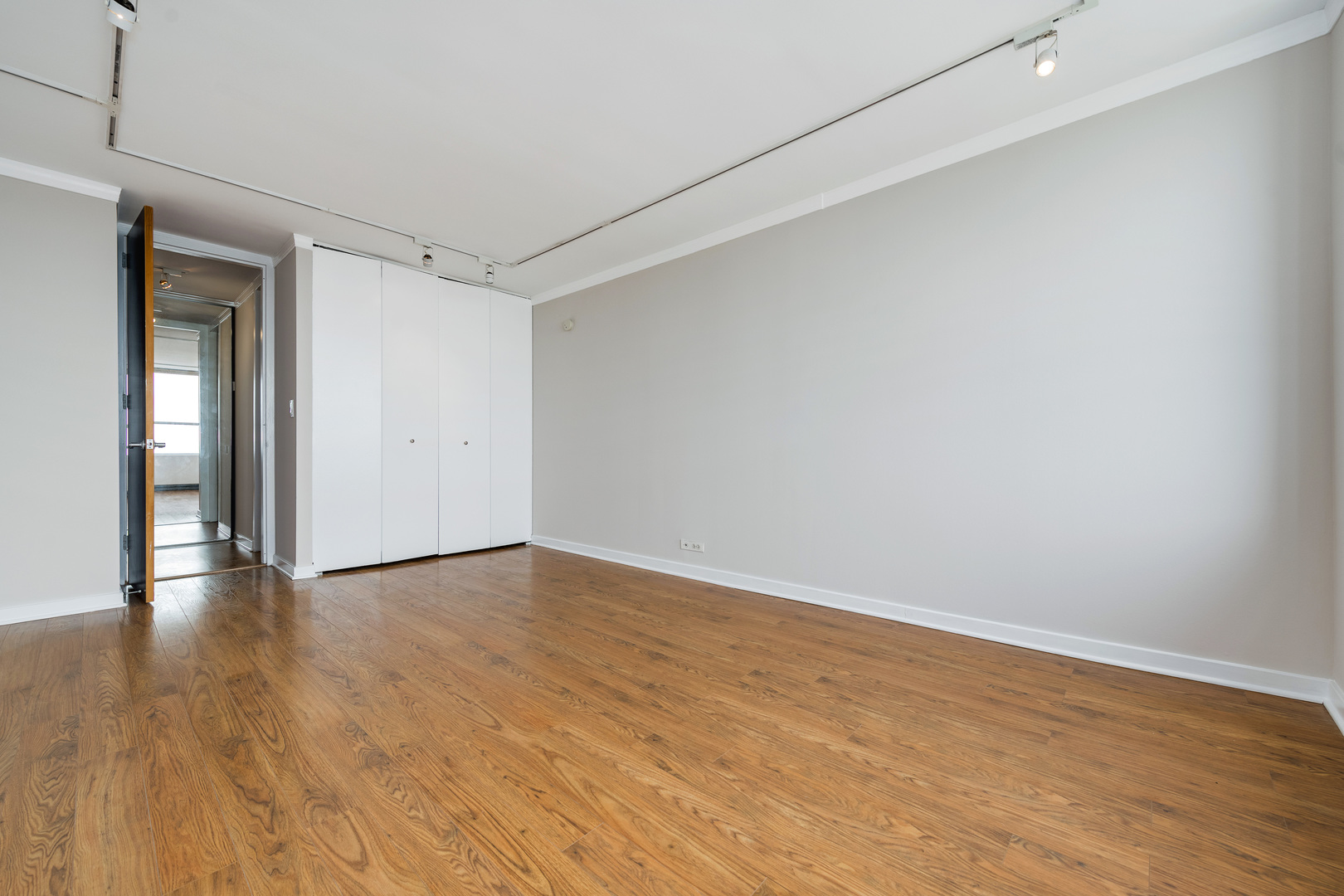 655 West Irving Park Road, Unit 5106 Chicago, IL 60613 - Photo 19 of 30 a view of an empty room with wooden floor and closet