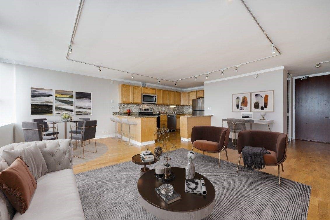 655 West Irving Park Road, Unit 5106 Chicago, IL 60613 - Photo 3 of 30 a living room with furniture a rug kitchen view and a window