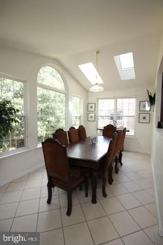 a view of a dining room with furniture and a large window