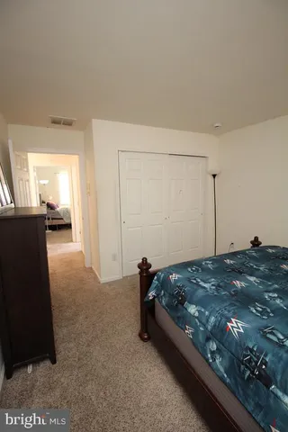 a bedroom with a bed and lamp