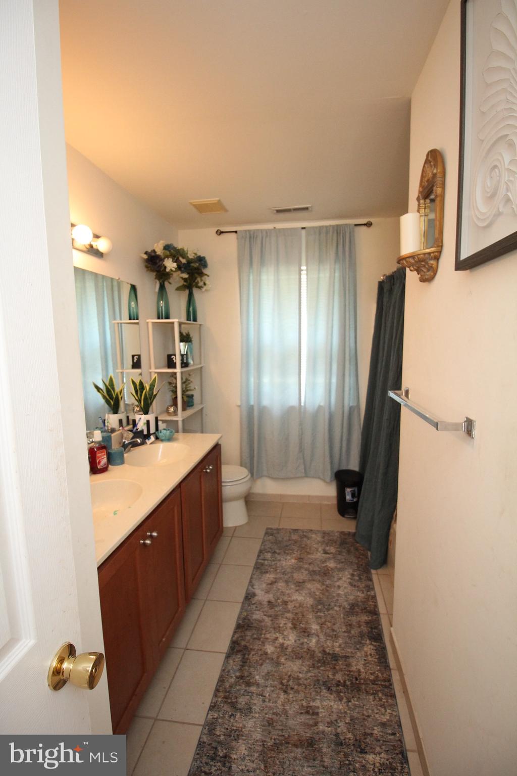 5 Kelly Drive Sicklerville, NJ 08081 - Photo 18 of 32 a bathroom with a sink a mirror and a shower