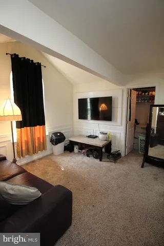 a view of a livingroom with furniture and a flat screen tv