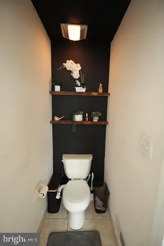 a bathroom with a toilet and a mirror