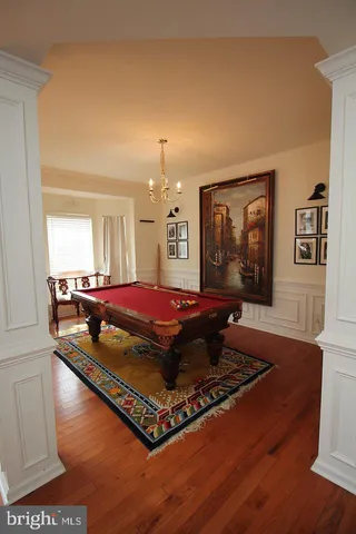 a living room with hard wood floors and a rug