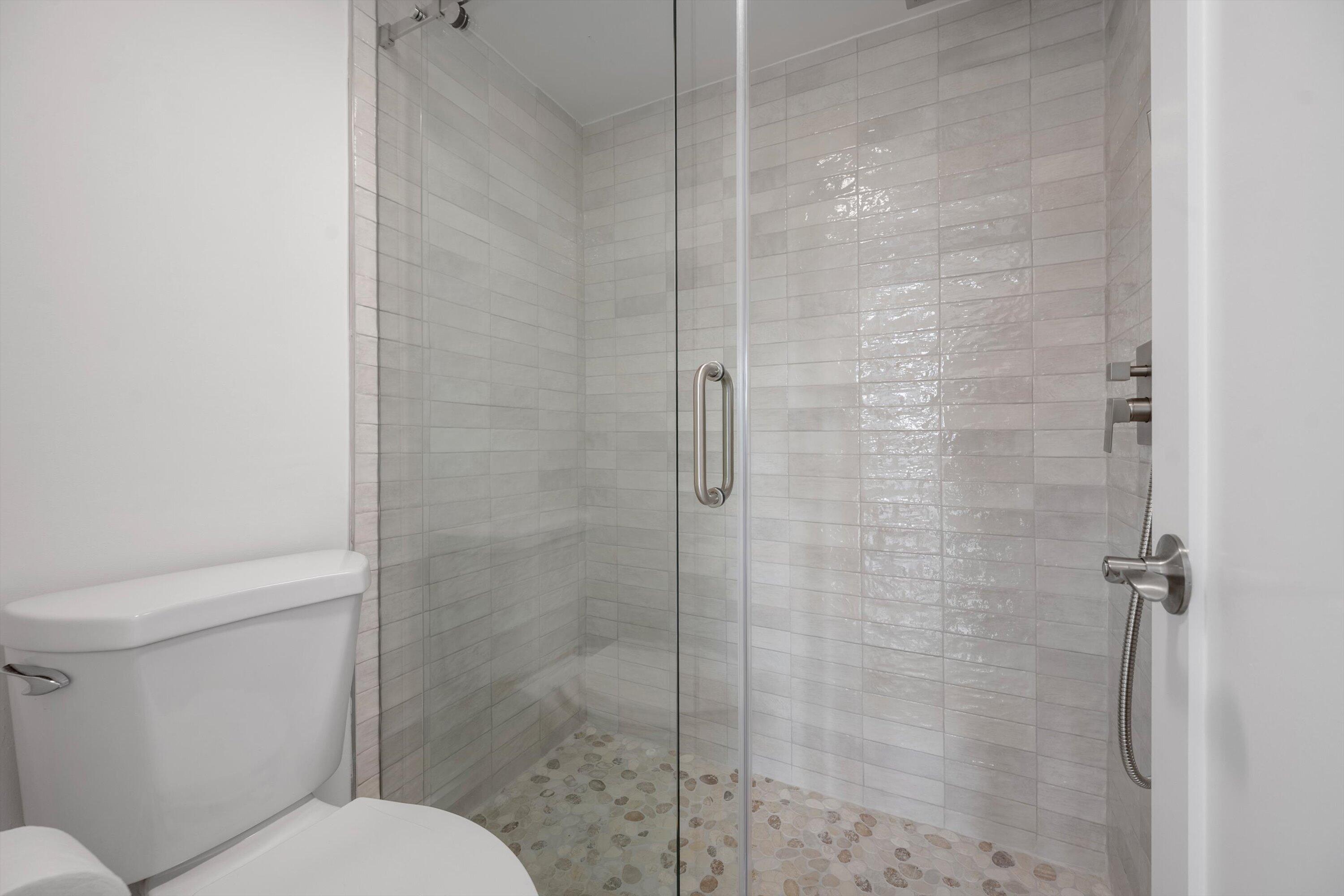 225 South Beach Road, Unit 102 Jupiter, FL 33469 - Photo 15 of 22 a bathroom with a toilet and a shower